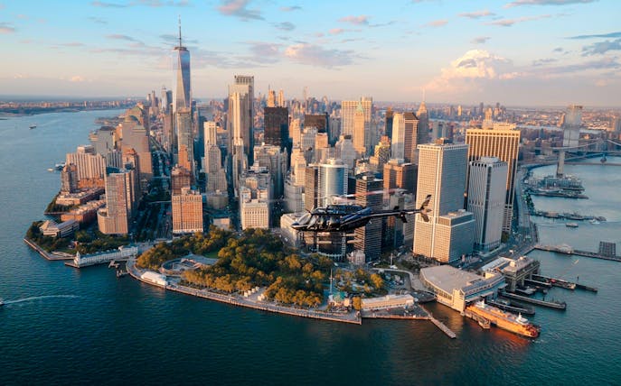 Helicopter flying over Lower Manhattan skyline, New York City.