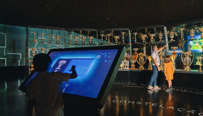 Visitors exploring exhibits in FC Porto Stadium Museum, Portugal.