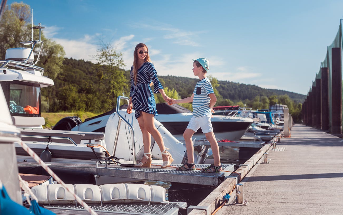 Boarding a boat for a trip on the Black Sea, with a woman and child walking on the dock.
