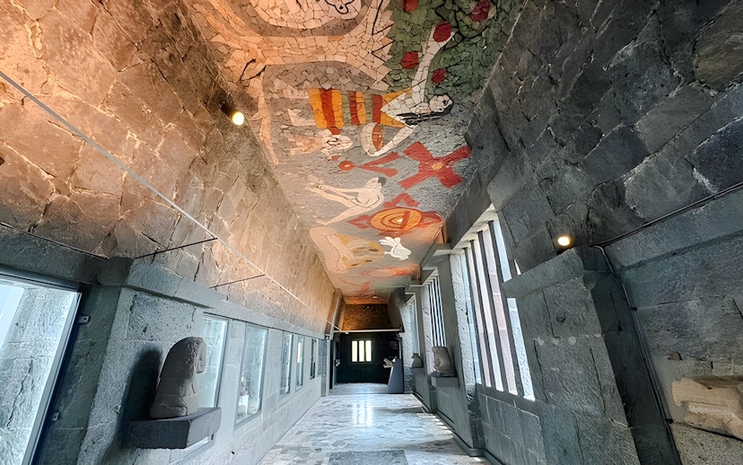 Hallway with mosaic ceiling and stone walls at Anahuacalli Museum, Mexico City.