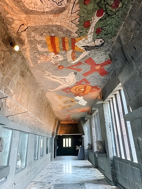 Hallway with mosaic ceiling and stone walls at Anahuacalli Museum, Mexico City.