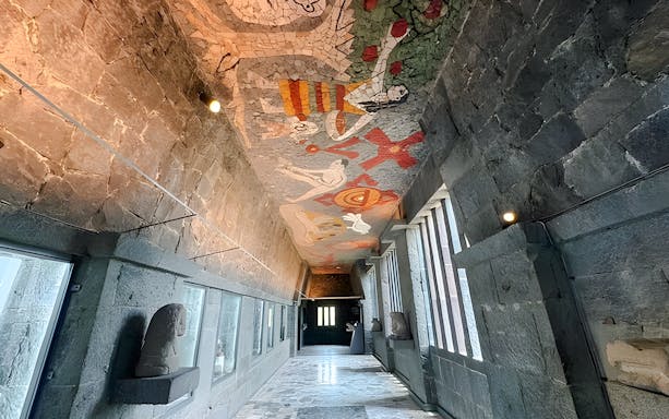Hallway with mosaic ceiling and stone walls at Anahuacalli Museum, Mexico City.