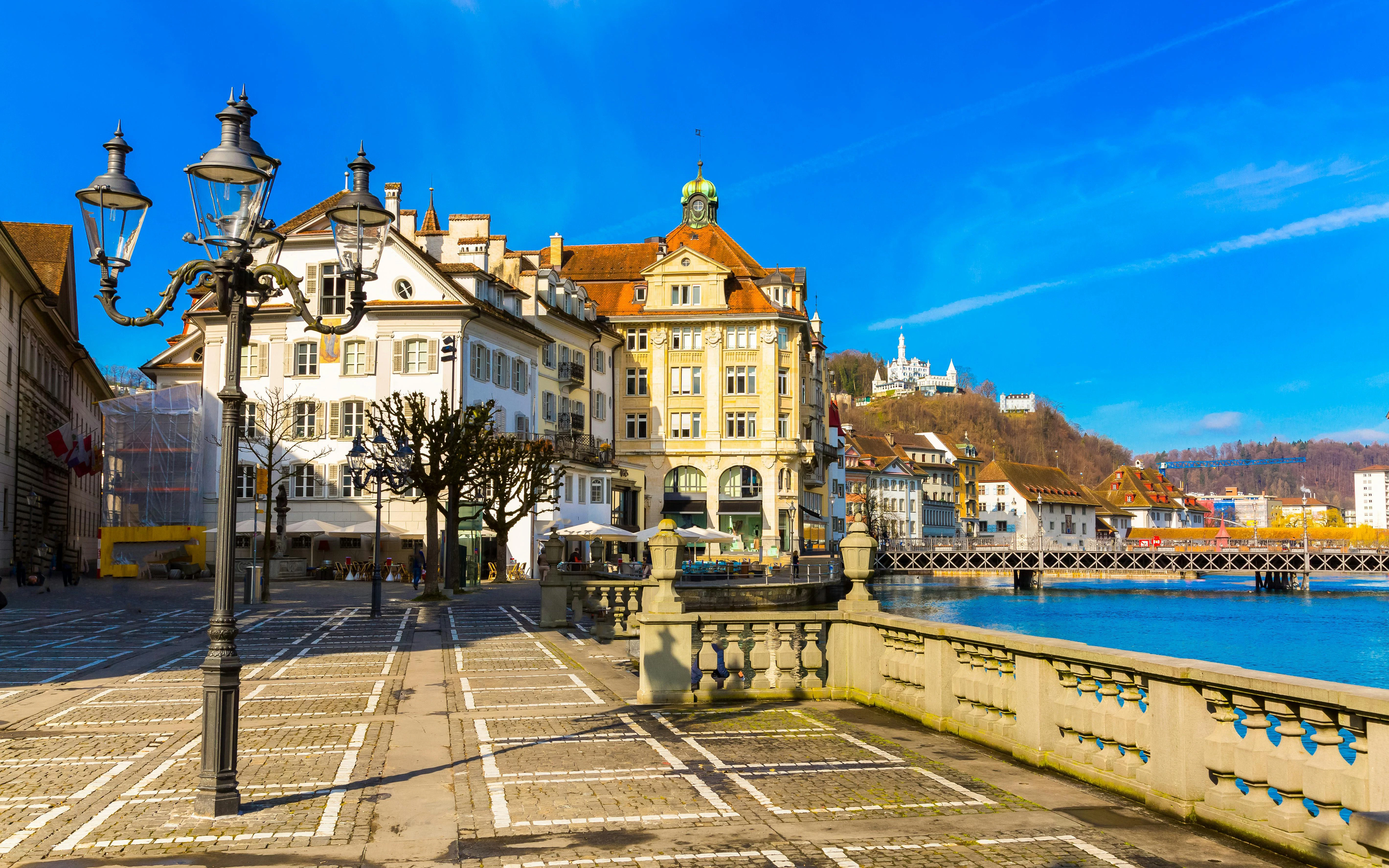 Old Town buildings along Reuss River in Lucerne, Switzerland, with a view of the waterfront.