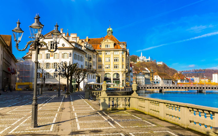 Old Town buildings along Reuss River in Lucerne, Switzerland, with a view of the waterfront.