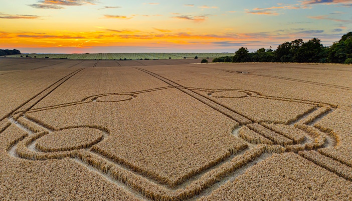 Crop circle in a wheat field at sunset, Normanton Down near Stonehenge.