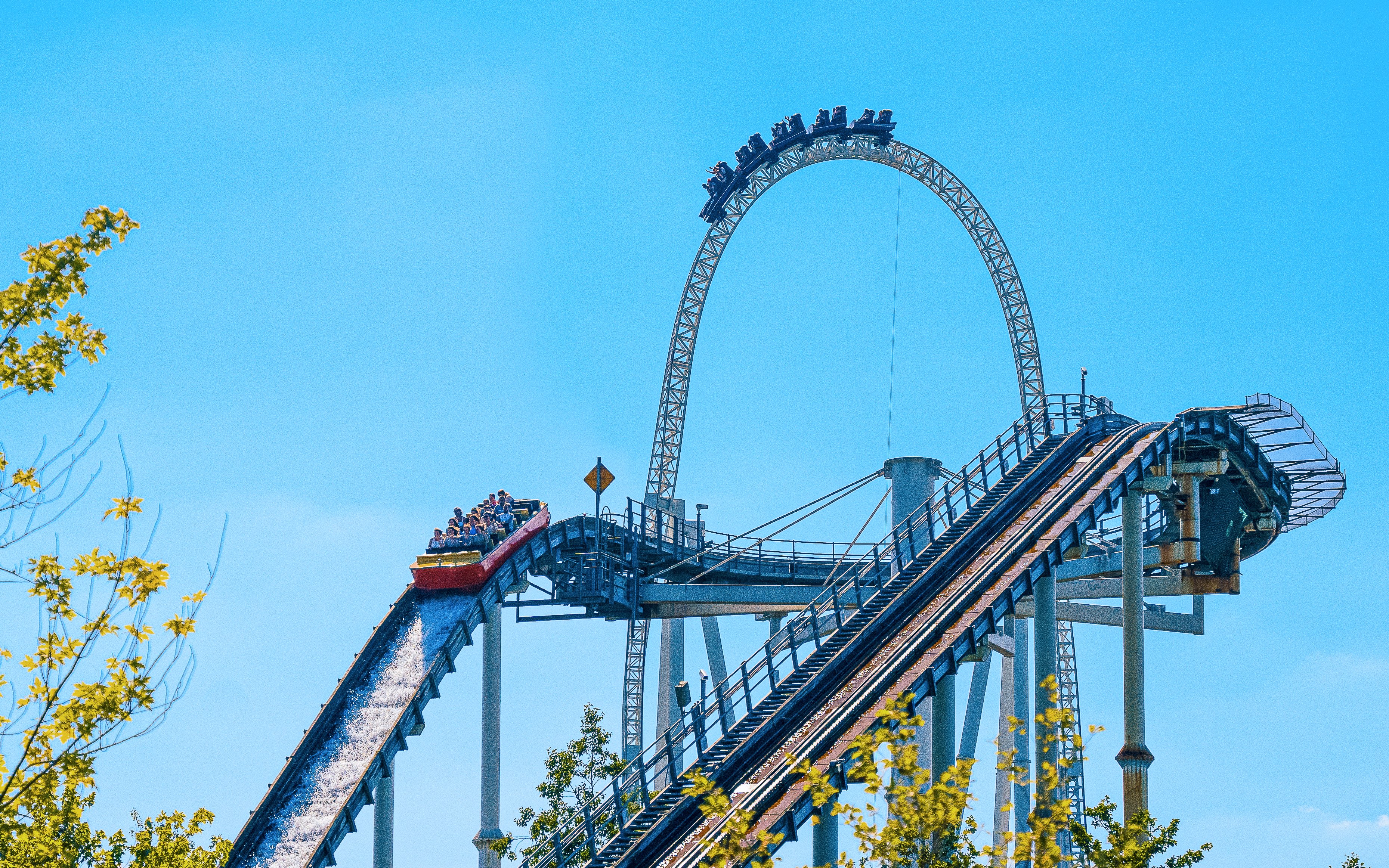 Roller coaster at Thorpe Park with riders descending a steep track.