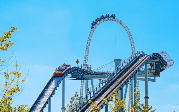 Roller coaster at Thorpe Park with riders descending a steep track.