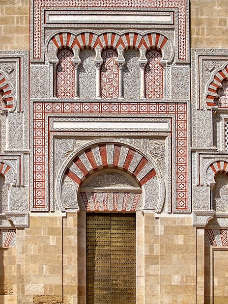 Entrance of the Cordoba Mosque-Cathedral with intricate arches and geometric patterns.