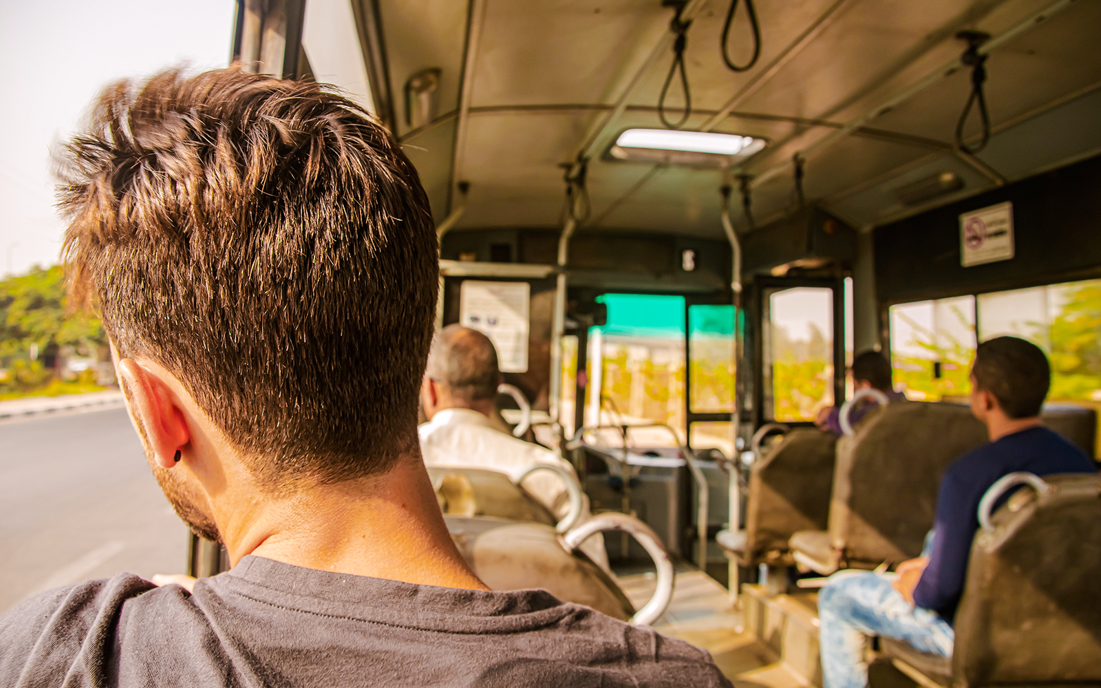 Man gazing out bus window in Egypt.