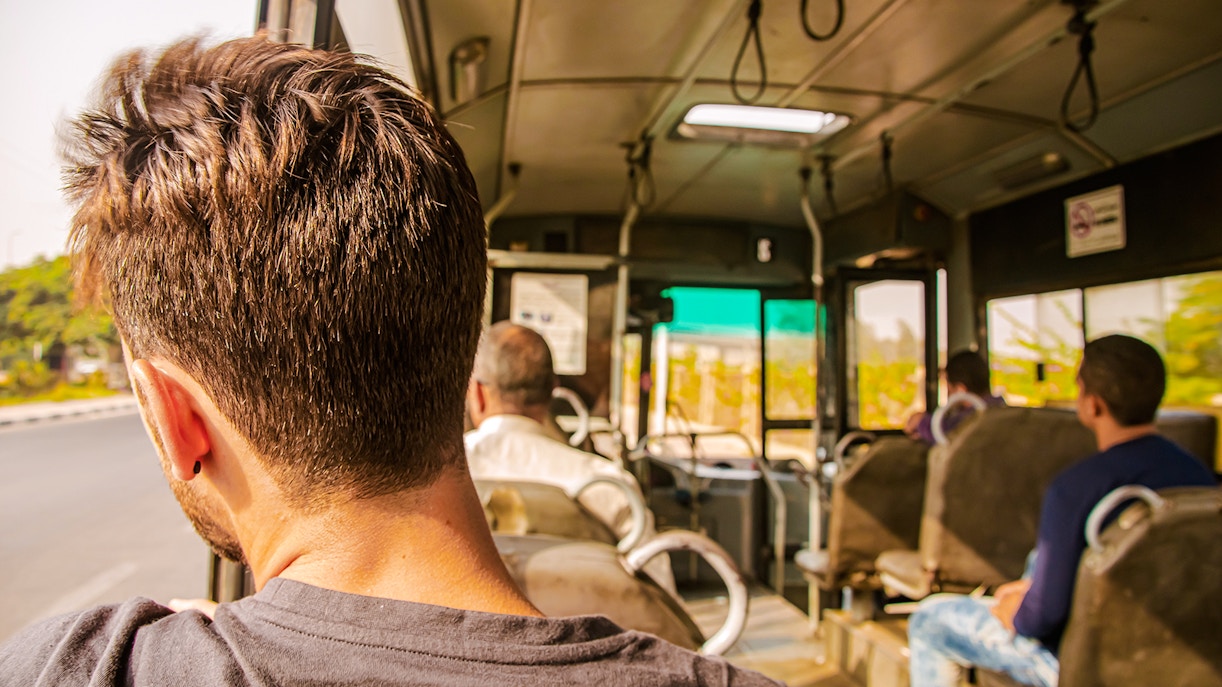 Man gazing out bus window in Egypt.