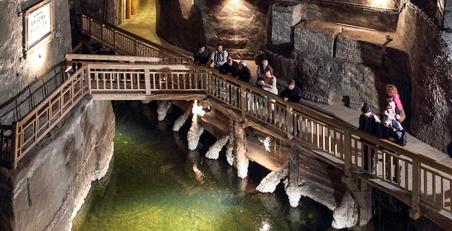 Visitors exploring wooden walkways inside Wieliczka Salt Mine near Krakow.