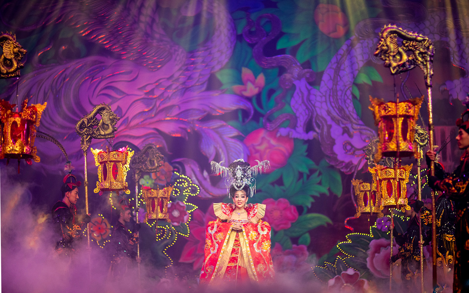 Performer in ornate costume on stage at Alcazar Cabaret Show, Pattaya, Thailand.