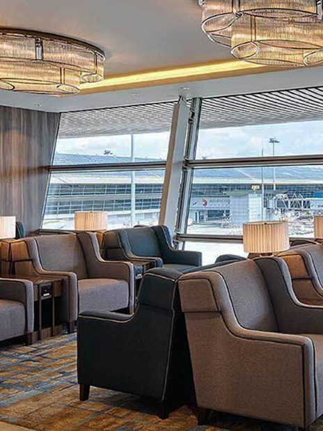 Plaza Premium First lounge seating area with airport view, Satellite Terminal.