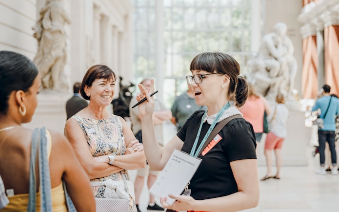 Guests engaging with a guide at the Metropolitan Museum of Art.