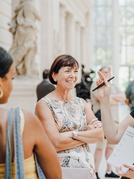 Guests engaging with a guide at the Metropolitan Museum of Art.