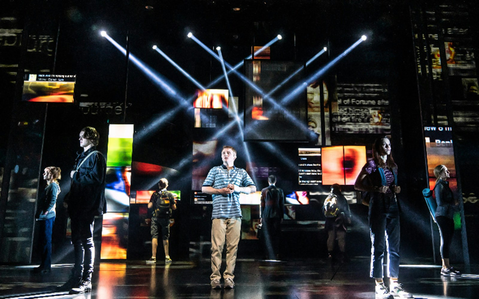 Stage performance of Dear Evan Hansen with actors under spotlights.