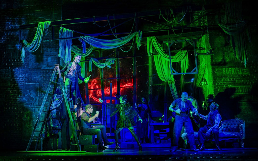 Stage performance of Moulin Rouge! The Musical in West End with actors in vibrant costumes.