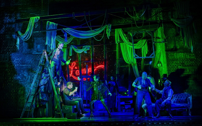 Stage performance of Moulin Rouge! The Musical in West End with actors in vibrant costumes.