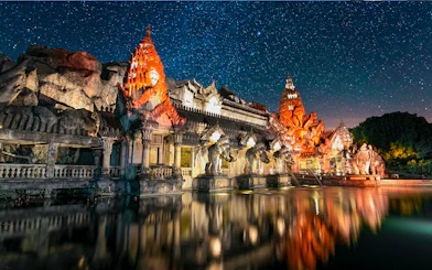 Phuket Fantasea illuminated temple with elephant statues at night, Phuket, Thailand.