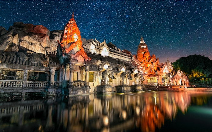Phuket Fantasea illuminated temple with elephant statues at night, Phuket, Thailand.