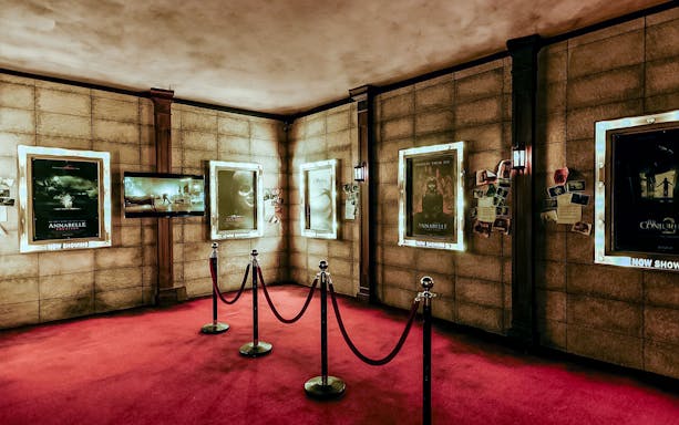 Movie posters from The Conjuring Universe displayed in a themed room in Malaysia.