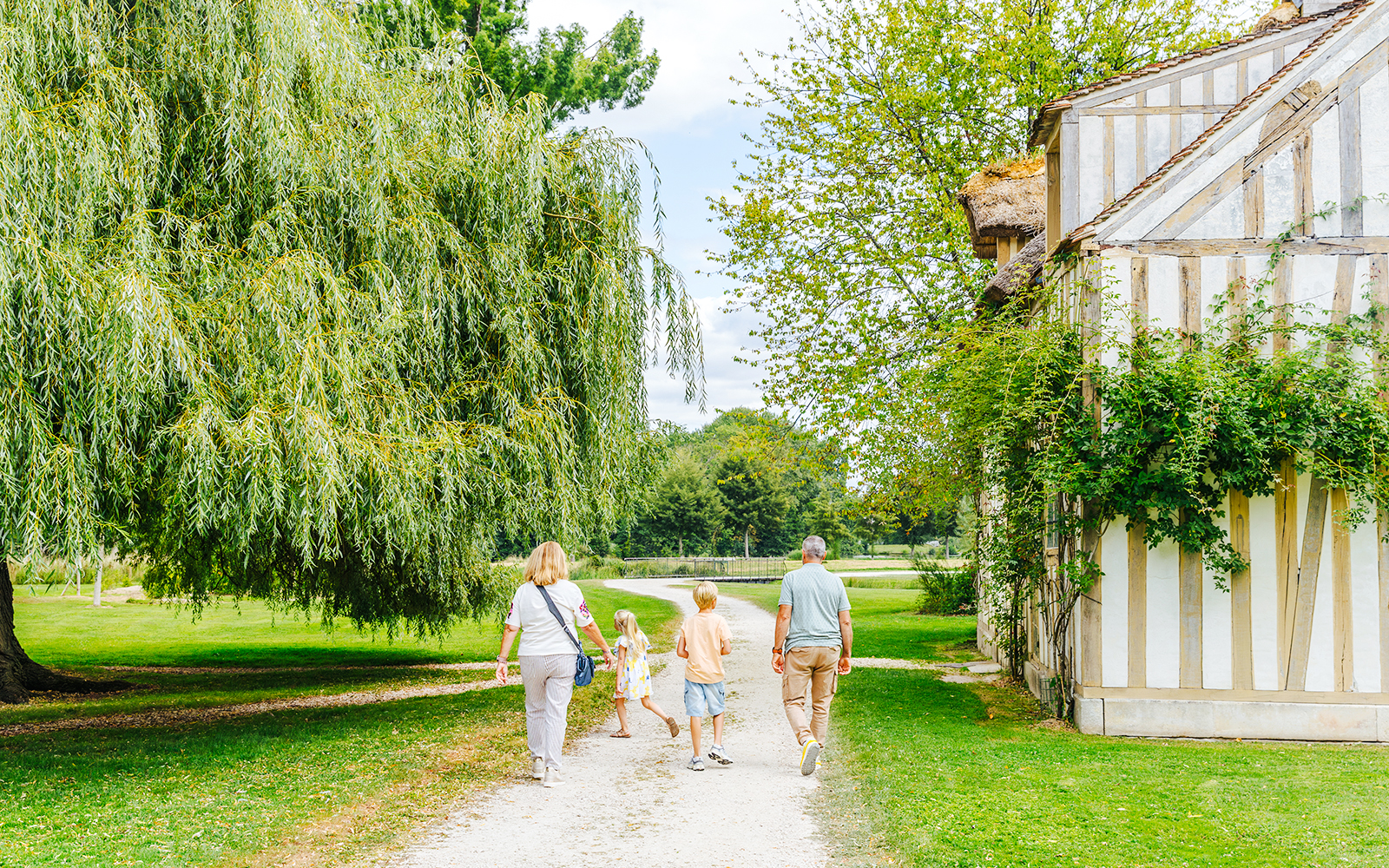 Family walking near a historic building at Chateau of Chantilly.
