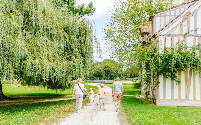 Family walking near a historic building at Chateau of Chantilly.