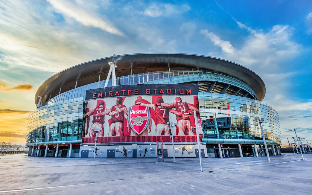 Emirates Stadium exterior with Arsenal FC mural, London.