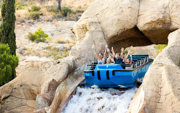 Visitors enjoying a water ride at Terra Mitica theme park in Spain.