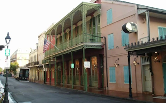Historic French Quarter street with wrought-iron balconies in New Orleans, part of the Phantom Ballerina game.