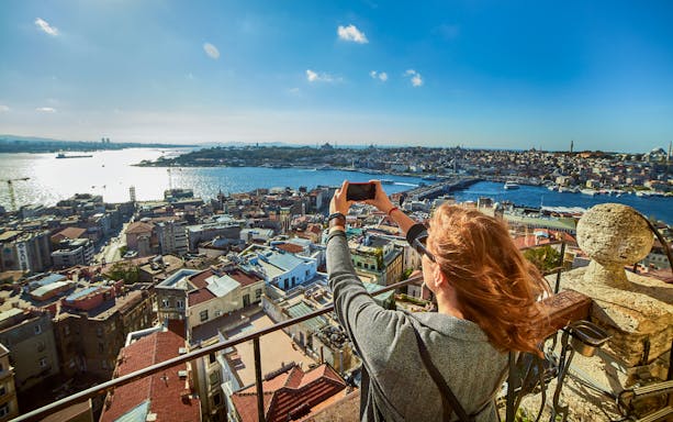 Person photographing Istanbul skyline and Bosphorus, Turkey.