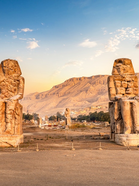 Colossi of Memnon statues at sunrise in Luxor, Egypt, part of 4-day Nile cruise tour.