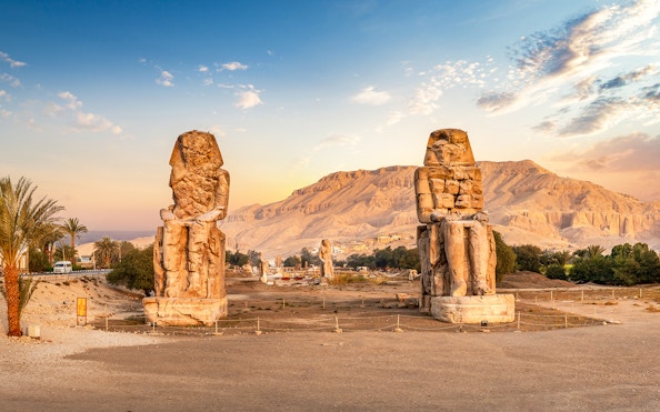 Colossi of Memnon statues at sunrise in Luxor, Egypt, part of 4-day Nile cruise tour.