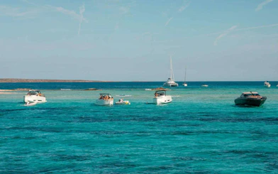 Boats cruising on turquoise waters between Ibiza and Formentera.