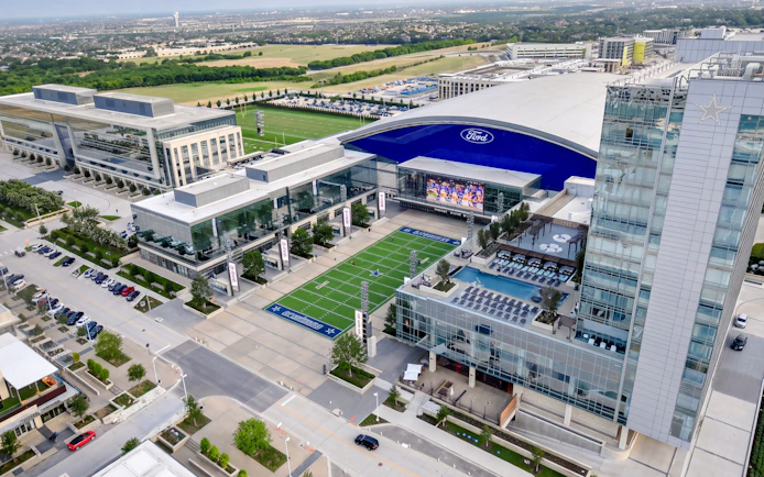 Aerial view of The Star complex in Frisco, Texas, featuring practice fields and surrounding buildings.