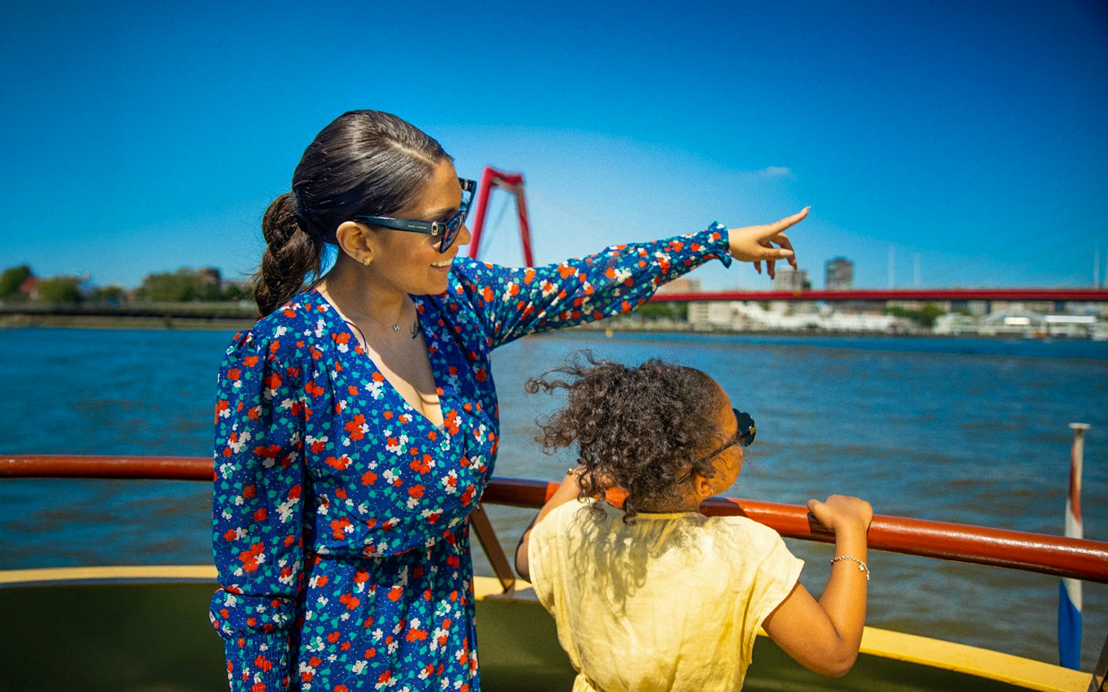 Guests enjoying a scenic view aboard the Pancake Cruise in Rotterdam, with city skyline in the background.