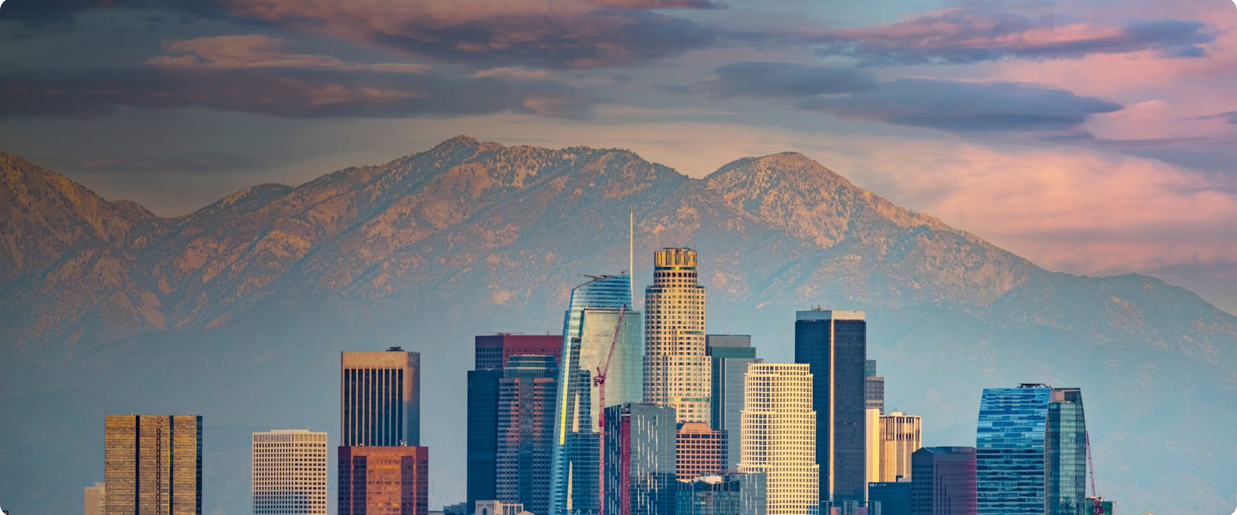 Los Angeles skyline with mountains in the background.