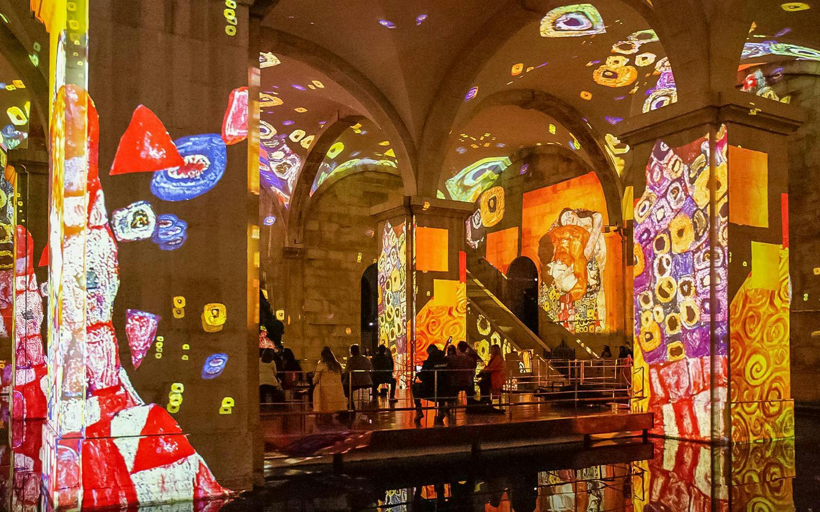 Immersive Monet and Klimt art projections in Lisbon exhibition hall.