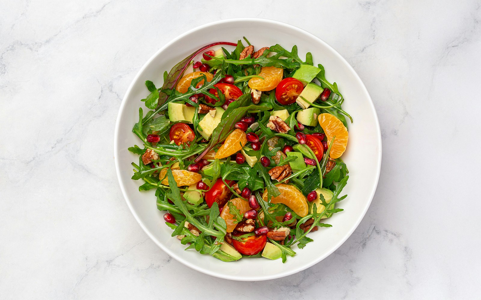 Tossed salad with arugula, cherry tomatoes, avocado, pecans, and citrus served on Steamboat Natchez Dinner Cruise.