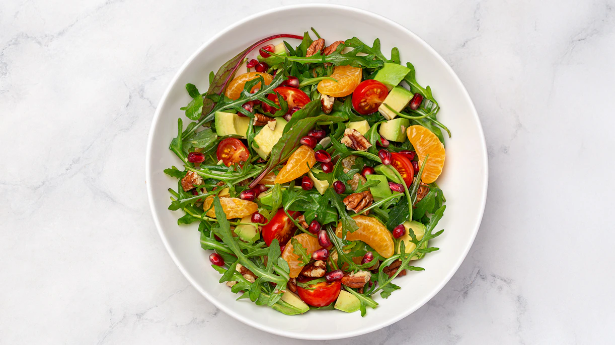 Tossed salad with arugula, cherry tomatoes, avocado, pecans, and citrus served on Steamboat Natchez Dinner Cruise.