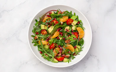 Tossed salad with arugula, cherry tomatoes, avocado, pecans, and citrus served on Steamboat Natchez Dinner Cruise.