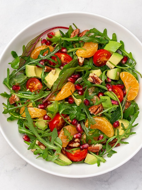 Tossed salad with arugula, cherry tomatoes, avocado, pecans, and citrus served on Steamboat Natchez Dinner Cruise.