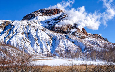 Snow-covered Mt. Usu with steam vents in Hokkaido during winter.