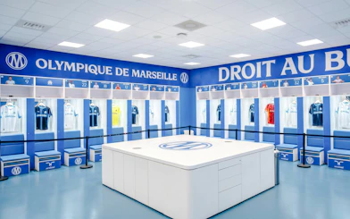 Olympique de Marseille locker room with team jerseys on display during OM Stadium Tour.