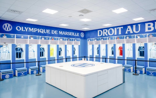 Olympique de Marseille locker room with team jerseys on display during OM Stadium Tour.