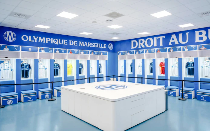 Olympique de Marseille locker room with team jerseys on display during OM Stadium Tour.
