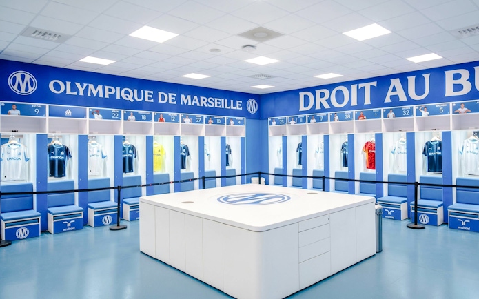 Olympique de Marseille locker room with team jerseys on display during OM Stadium Tour.