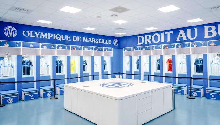 Olympique de Marseille locker room with team jerseys on display during OM Stadium Tour.