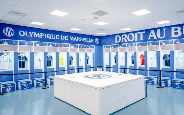 Olympique de Marseille locker room with team jerseys on display during OM Stadium Tour.