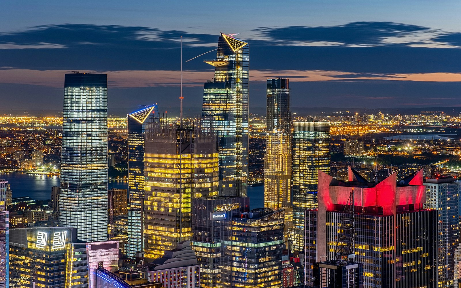 Midtown Manhattan skyline view from Rockefeller Center rooftop at dusk.